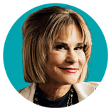 profile-shari-blue-background-white-jacket-circle-250x250
