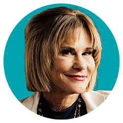 profile-shari-blue-background-white-jacket-circle-250x250